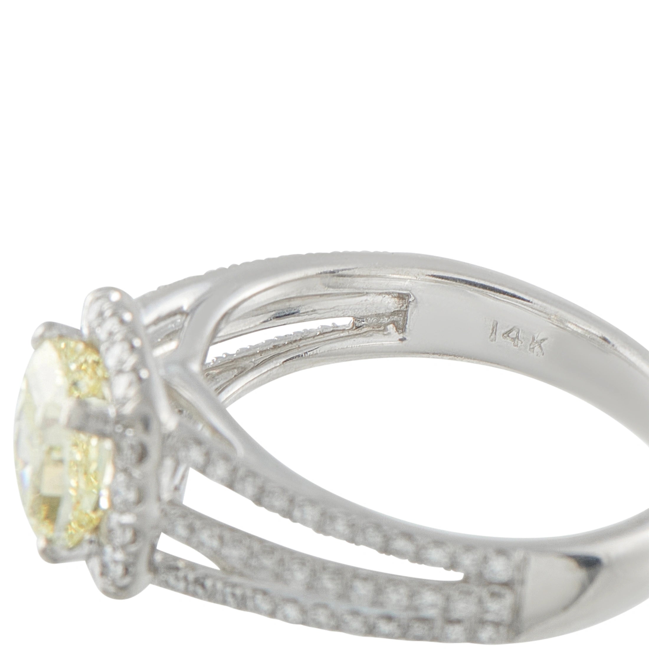 14K white gold ring close-up with yellow center diamond and engraved settings