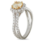 14K white gold ring with oval fancy yellow diamond halo and pavé diamond band