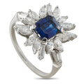 14K white gold starburst ring with dark blue sapphire center and diamond accents