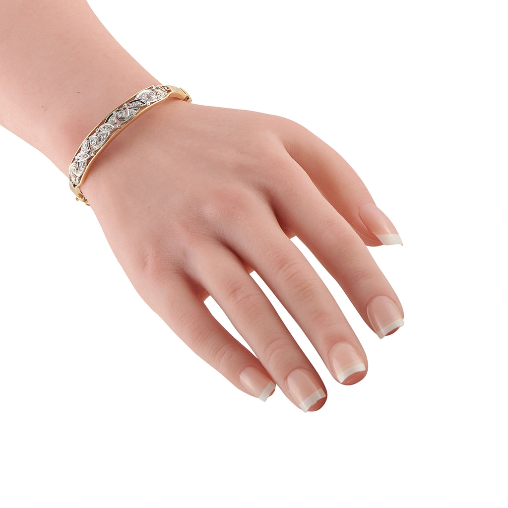 Yellow gold diamond bracelet on wrist, row of round-cut stones