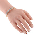 Yellow gold diamond bracelet on wrist, row of round-cut stones