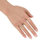 Diamond ring on hand: 14k yellow gold band with oval center and round side stones