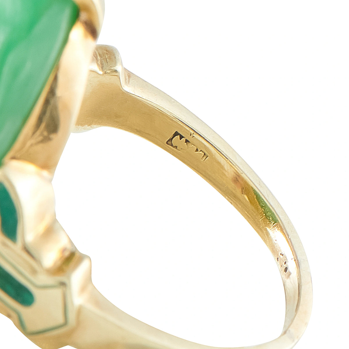 Yellow gold ring shank close-up with stamped marks, green enamel and jade base