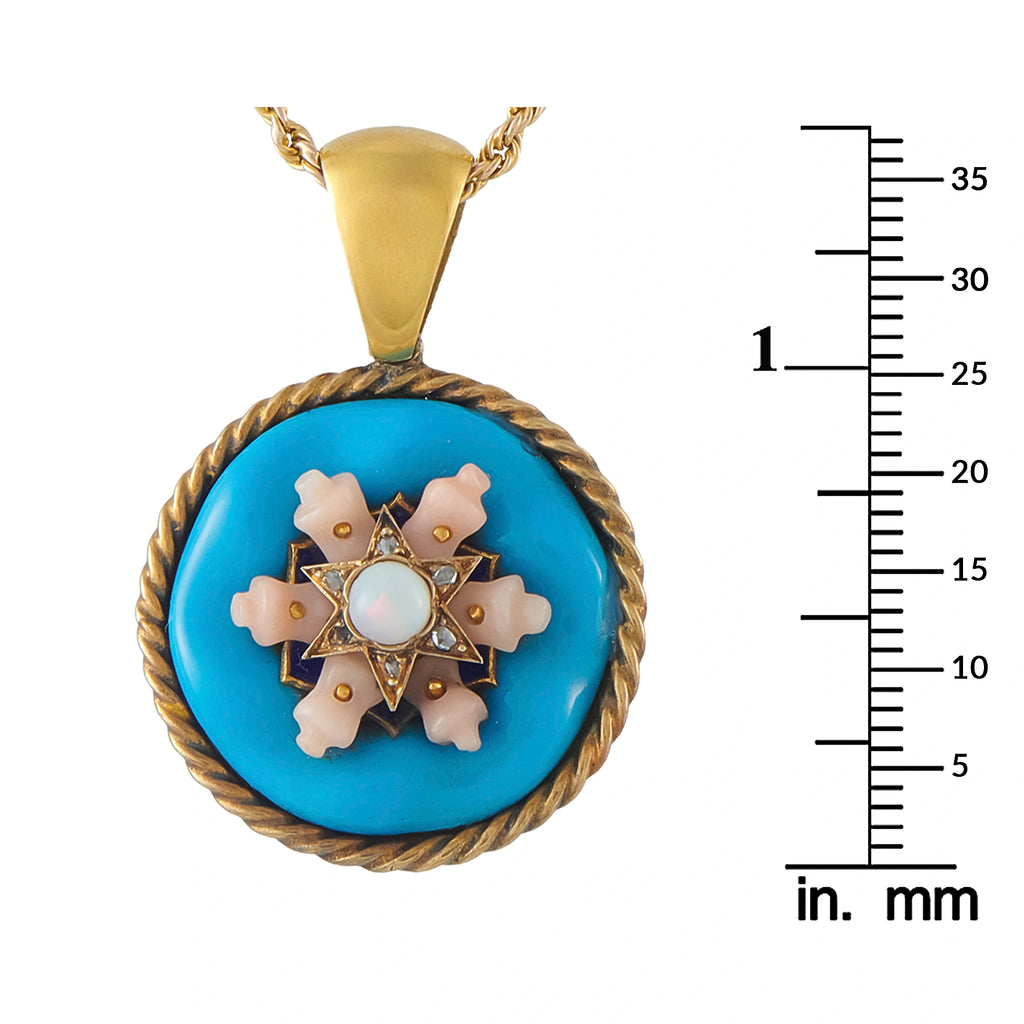 Gold tone round pendant necklace with blue enamel floral design and rope rim