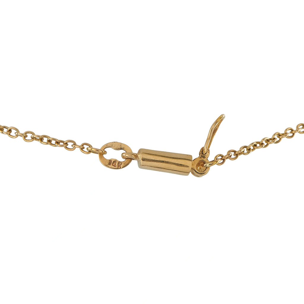 Gold clasp and chain of ornate cross necklace with small pearl details