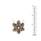 Antique-style cross necklace pendant with pearls and dark accents beside size ruler