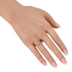 Diamond openwork rose gold band worn on finger, round pave stones visible