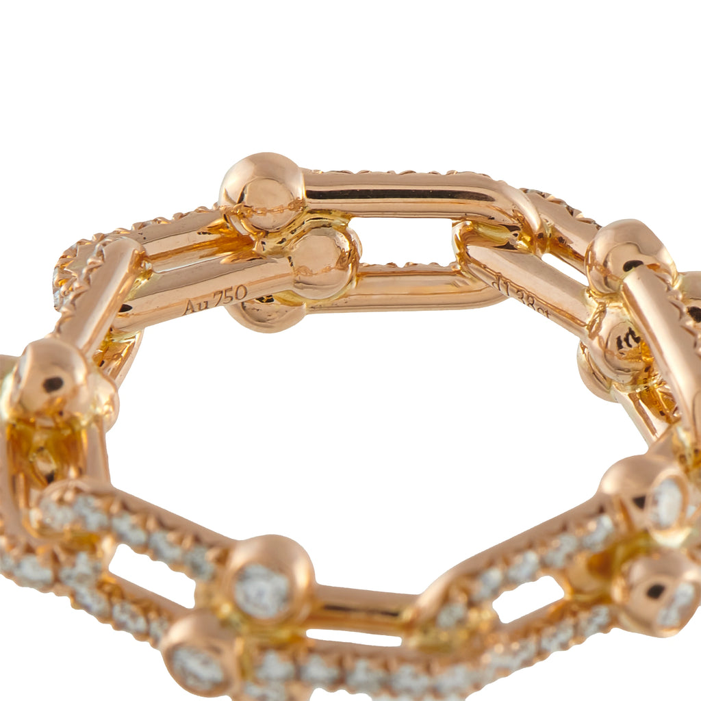 Rose gold diamond band close-up showing inner rail and linked bezel settings