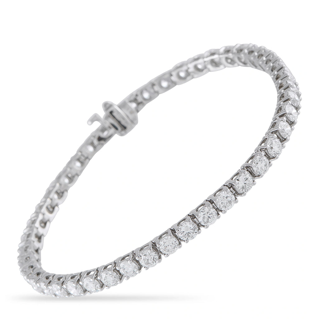 White gold diamond tennis bracelet with oval-cut stones and box clasp, hinged design