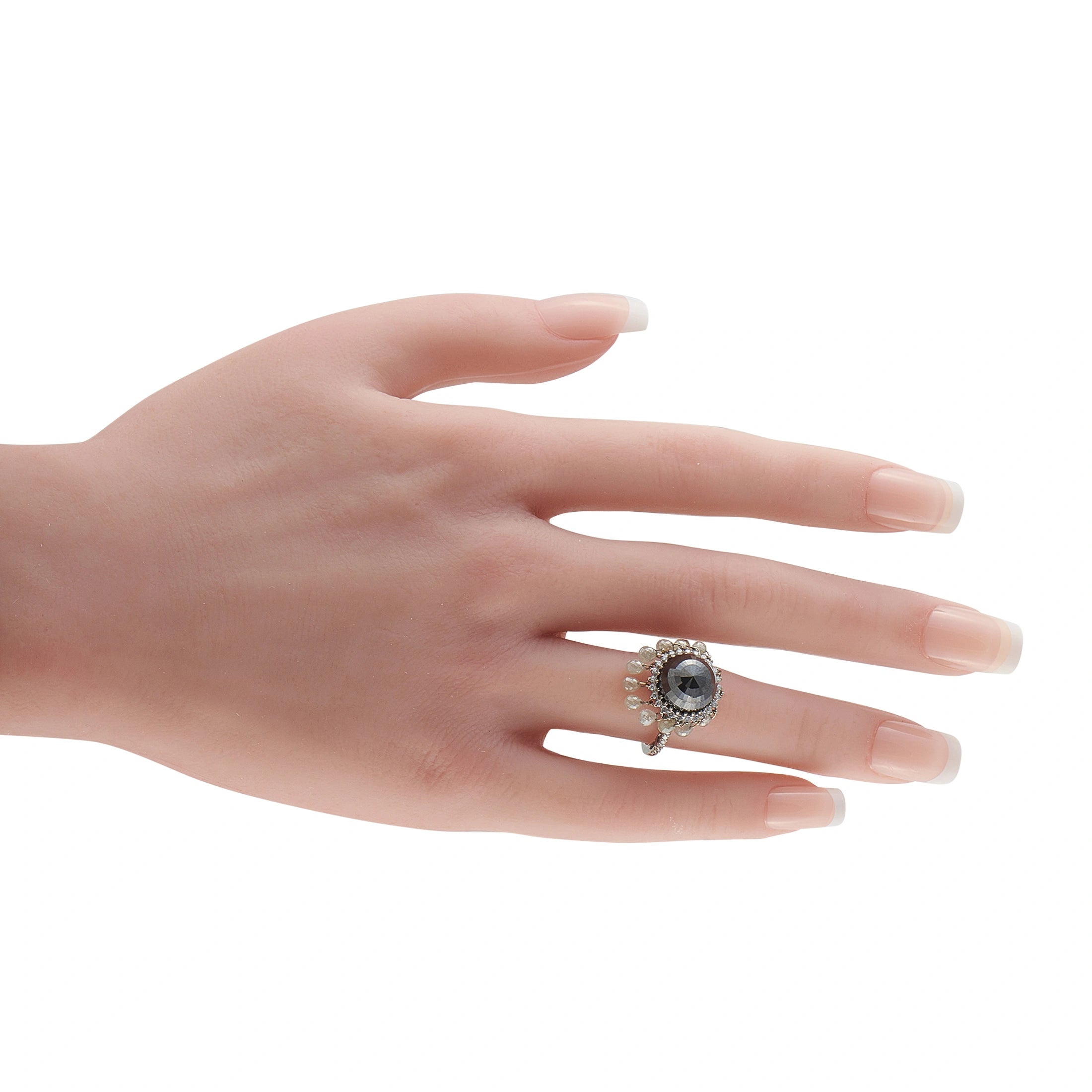 18K white gold diamond ring on hand, dark center stone with white halo and drop accents