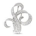Antique 18K white gold diamond brooch with swirling openwork design
