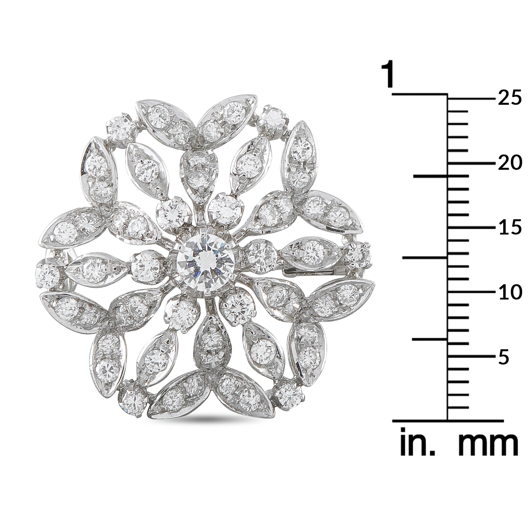 White gold diamond cluster flower brooch shown with mm size ruler for scale