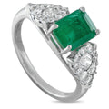 White gold ring with emerald green center and diamond halo clusters