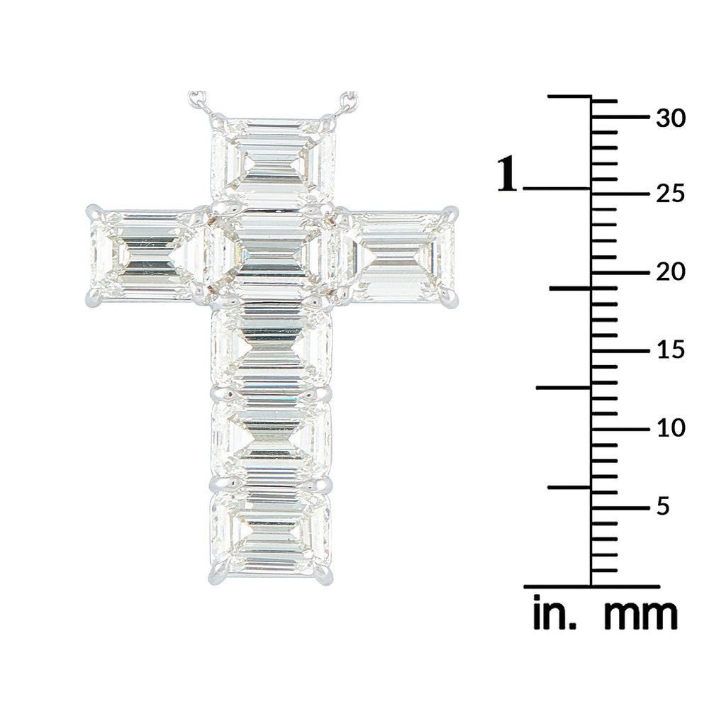Baguette-cut diamond cross pendant shown beside a millimeter ruler