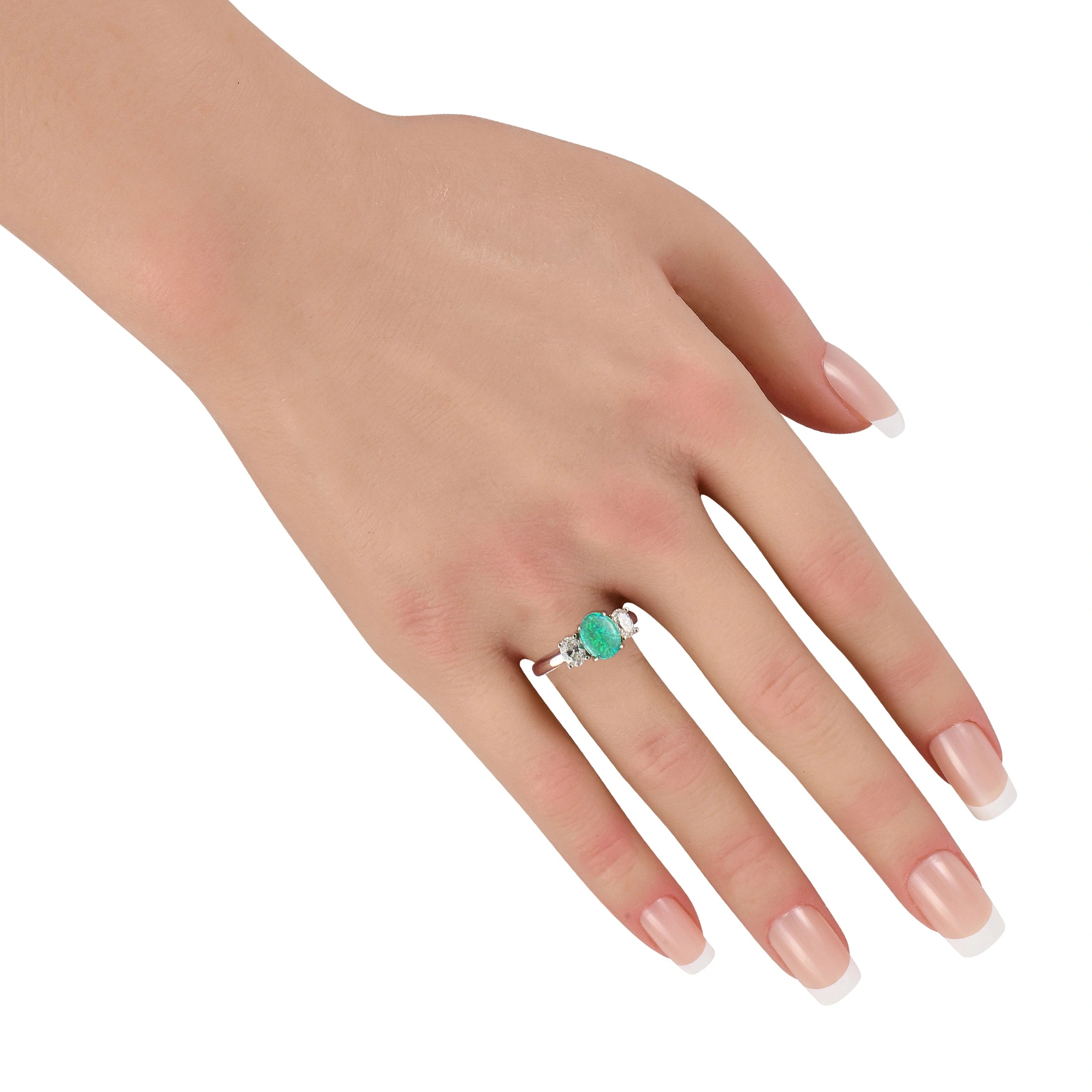 White gold three-stone ring on hand, oval green opal with diamond side stones