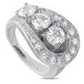 Antique 18K white gold diamond ring with three round stones and pavé halo