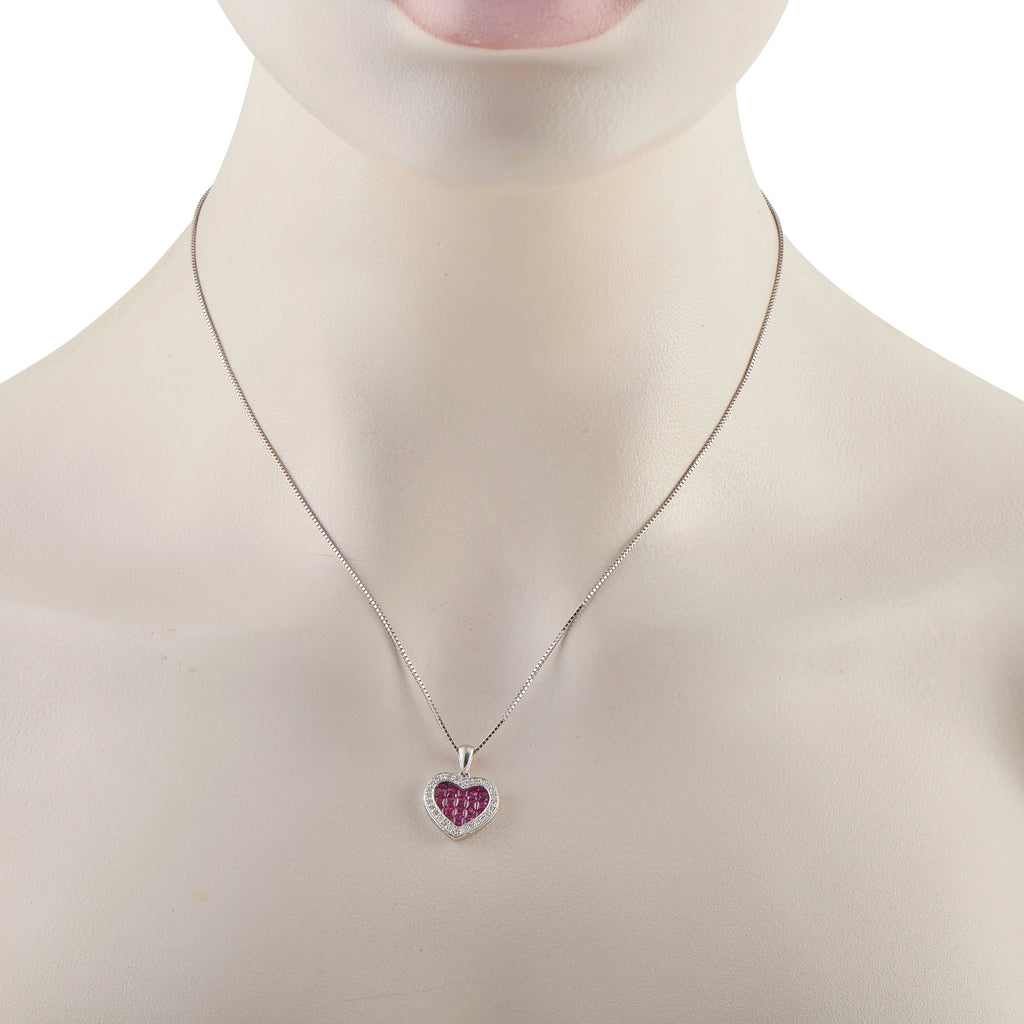 Heart pendant on a fine chain: ruby red heart with diamond border in white gold