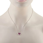 Heart pendant on a fine chain: ruby red heart with diamond border in white gold