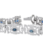 Close-up white gold bracelet clasp and links with blue sapphires and diamond details