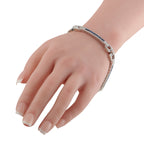Art Deco white gold bracelet worn on hand, blue sapphire insets and diamond geometric links