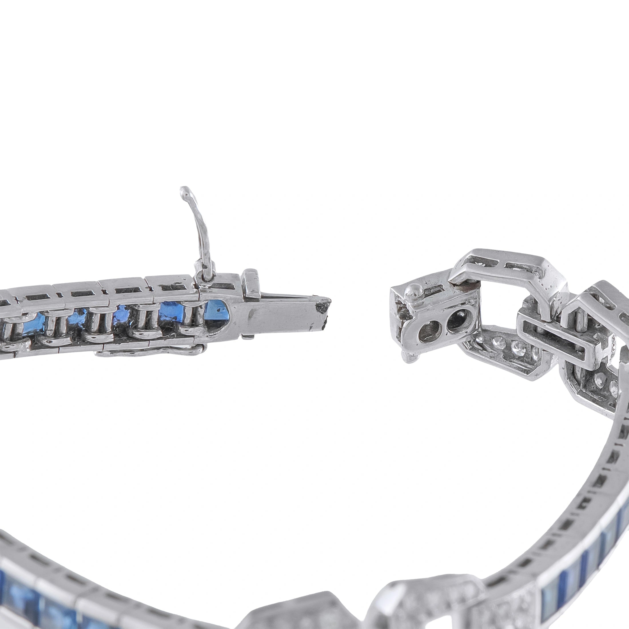 Art Deco white gold bracelet close-up of clasp, blue sapphire inlays and diamond-set links