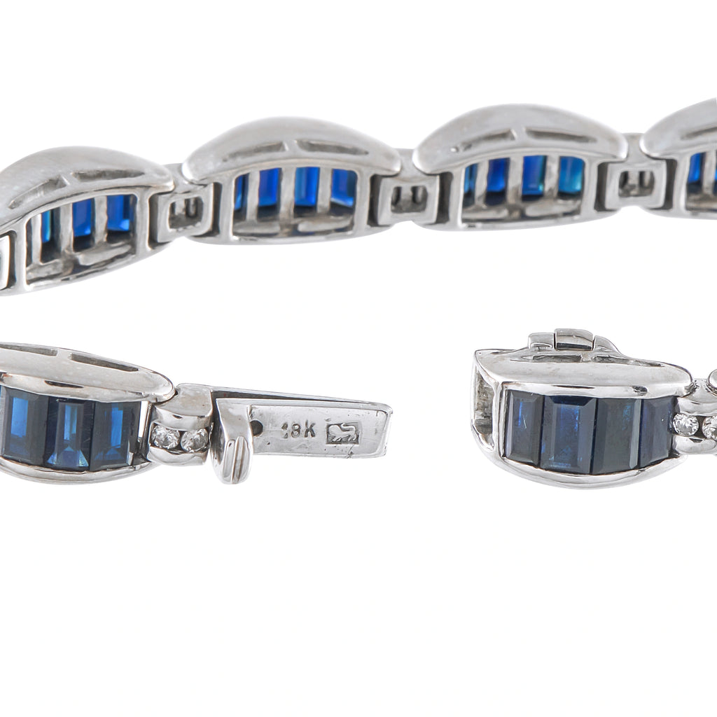 White gold bracelet close-up with blue baguette sapphires, diamond details, and clasp