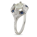 18K white gold ring with round diamond center and blue sapphire side stones