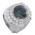 White gold cocktail ring with dark oval gemstone and diamond cluster setting
