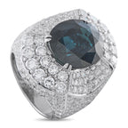 White gold cocktail ring with dark oval gemstone and diamond cluster setting