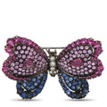 Butterfly brooch with pink and blue gemstone wings and central diamond accents