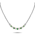 Gold necklace with round green emeralds and diamond accents in a line