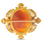 Antique-style gold cameo brooch with oval orange agate face and pin bar; pearls and blue enamel