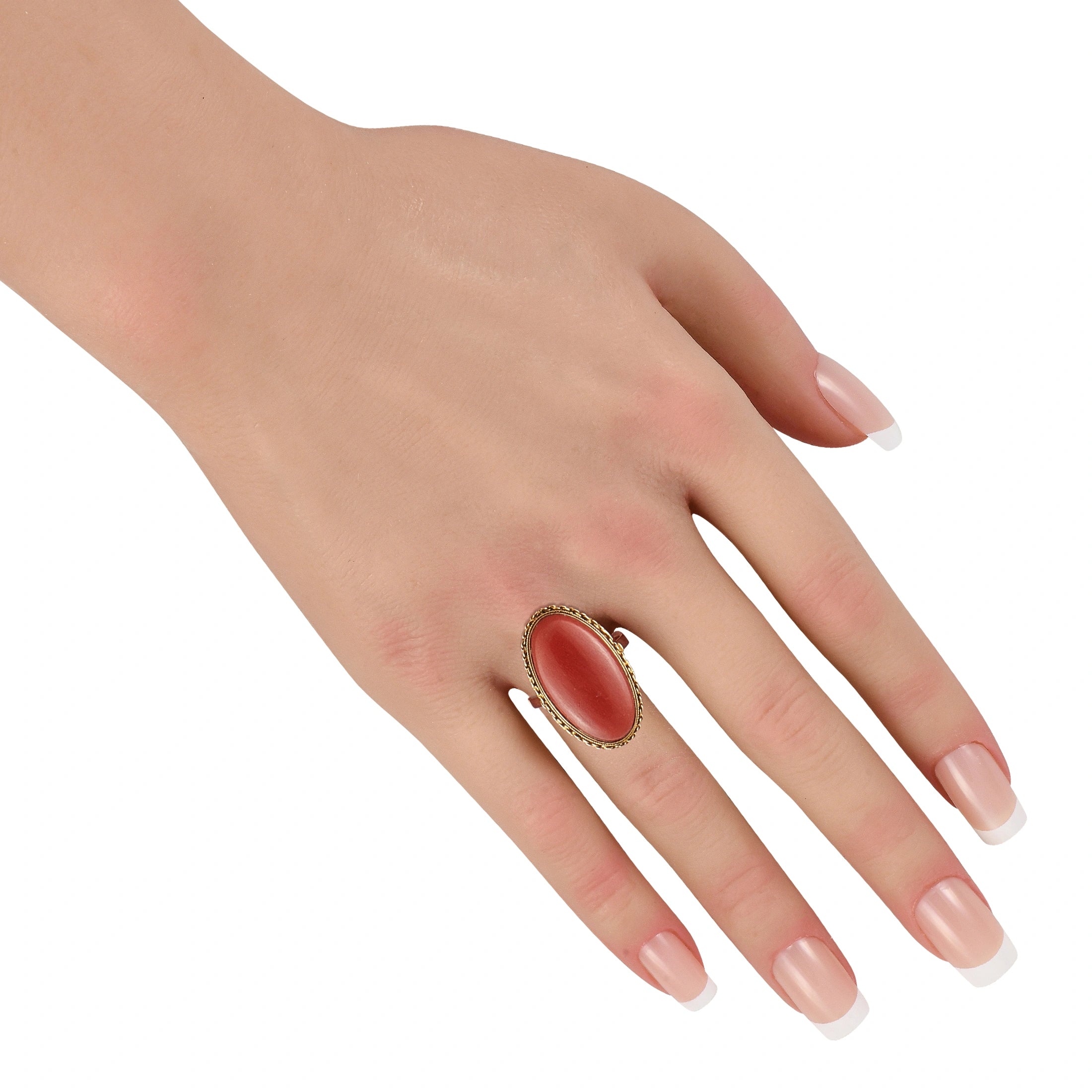 18K yellow gold coral cocktail ring worn on hand, oval coral-red stone visible