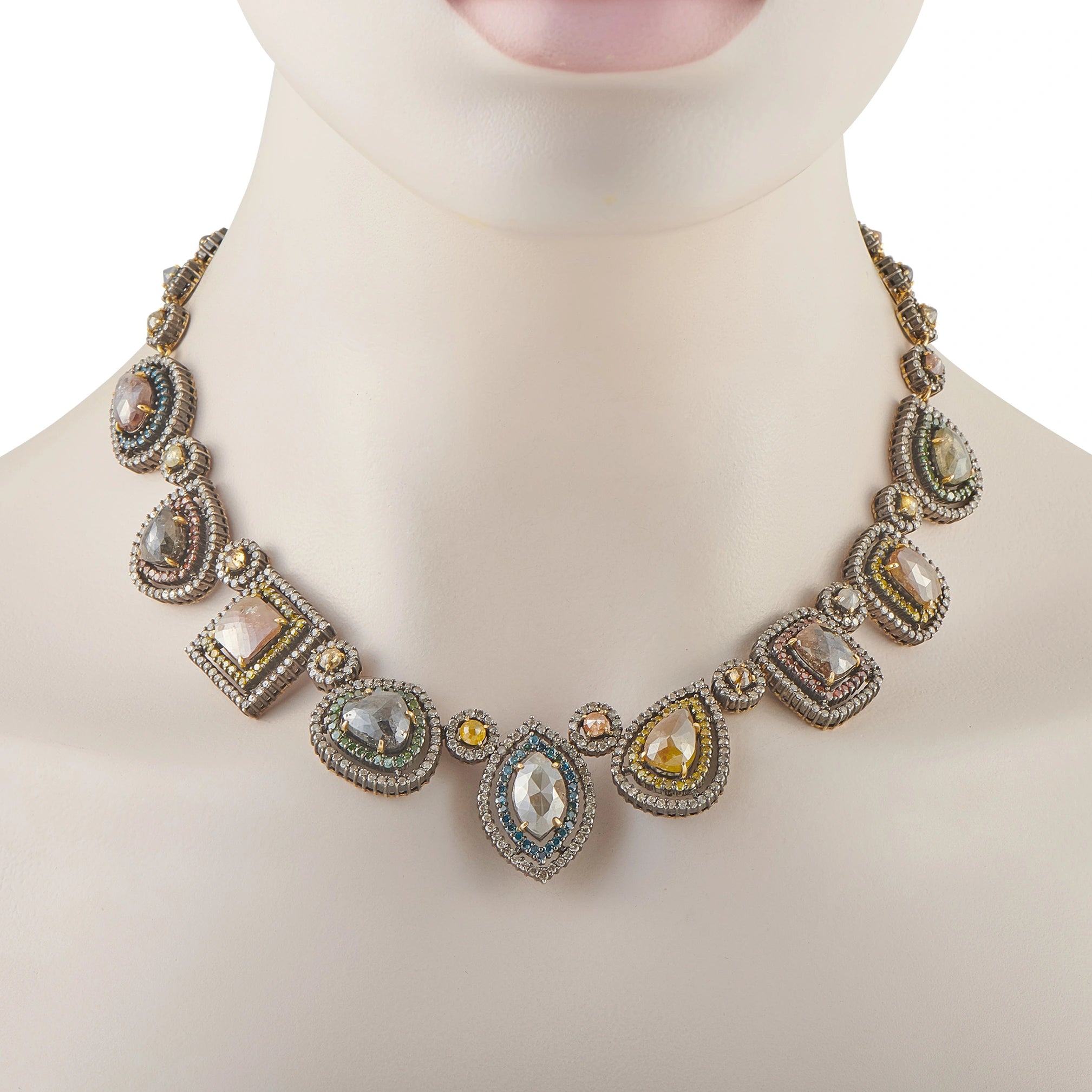 Yellow gold diamond halo necklace on mannequin with linked oval and pear stones
