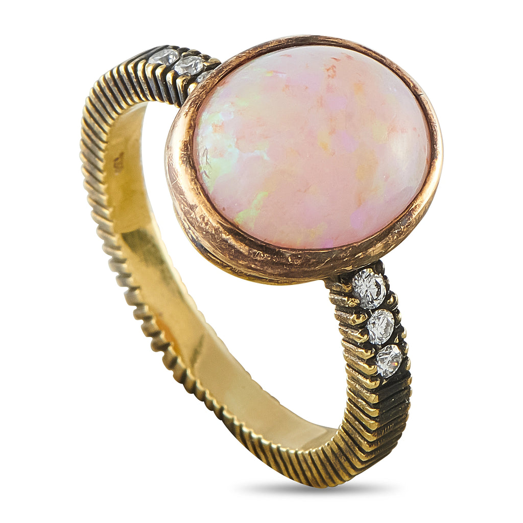 18k yellow gold oval opal ring with diamond accents, ribbed band and bezel setting