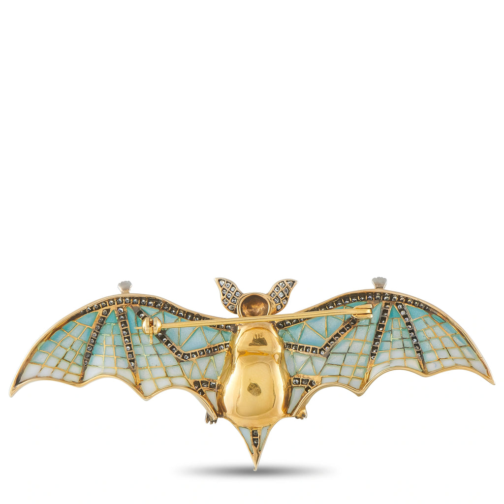 Gold bat brooch with blue enamel mosaic wings and central gold body with pin