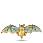 Gold bat brooch with blue enamel mosaic wings and central gold body with pin