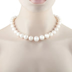 White pearl bead necklace with tightly spaced round pearls shown on the neckline