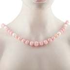 Pink and white beaded necklace with small gold links along the strand