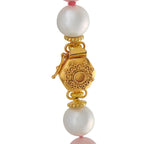 Gold-tone filigree centerpiece necklace with white round beads and pink stone accents