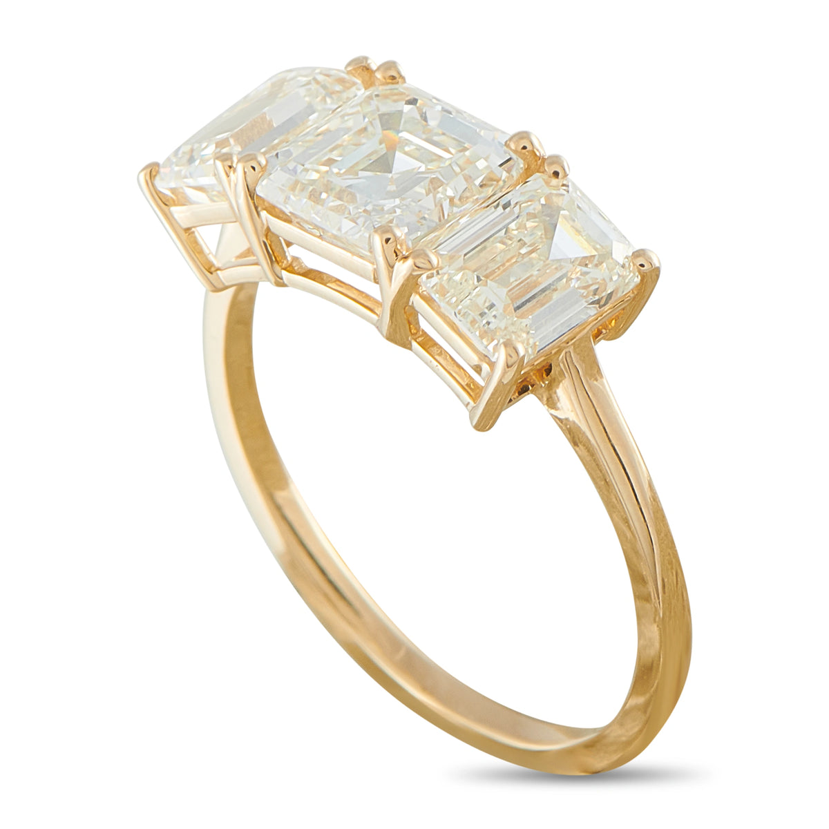 Three-stone yellow gold ring with three square clear diamonds, bezel-set