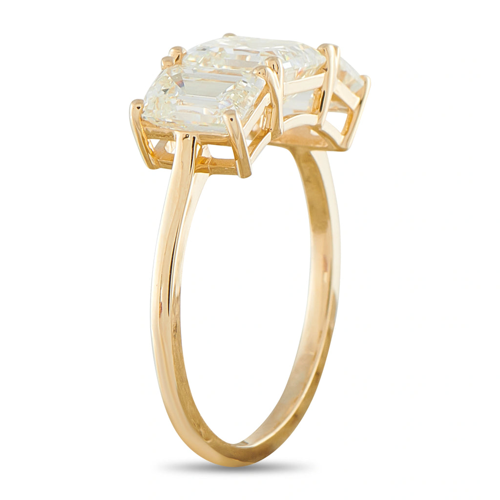 Yellow gold three-stone ring with large square center diamond and side diamonds