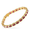 Gold tennis bracelet with ruby-colored square stones and small diamond accents