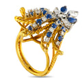 Yellow gold fleur de lis ring with blue sapphires and clear diamonds, openwork