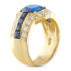 18K gold ring side view with large blue sapphire and round diamond accents