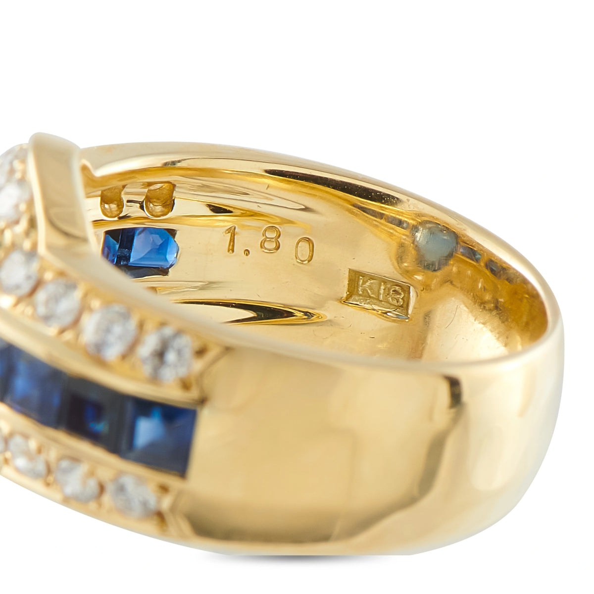 Gold ring interior band with K18 hallmark and set blue sapphire
