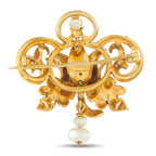 Gold-tone enamel brooch with pearl drop, ornate scroll frame, and straight pin back