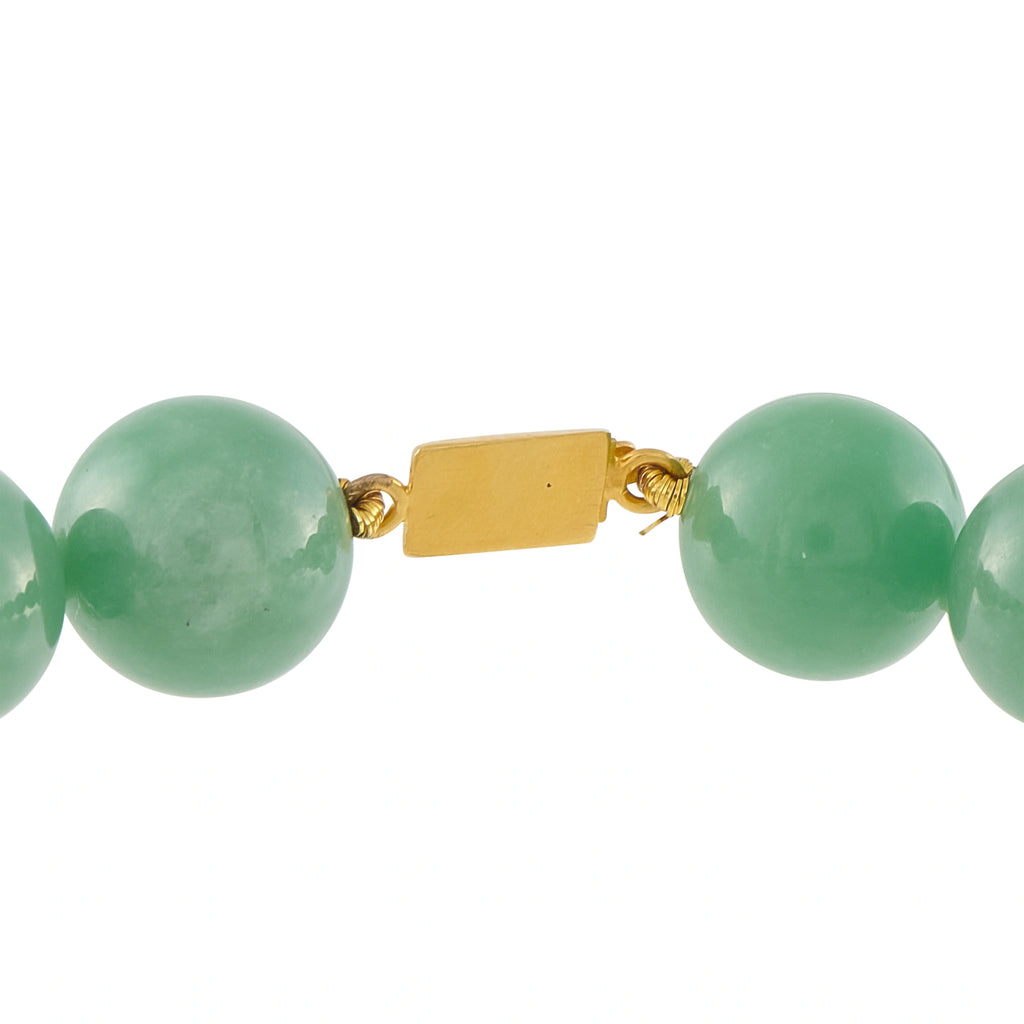 Green jade bead bracelet with yellow gold rectangular clasp and barrel connectors