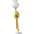 White pearl pendant necklace with gold oval charm and dangling gold detail