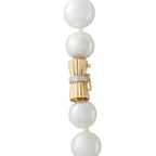 Gold clasp with pearl drops and crystal-like connector accents on necklace